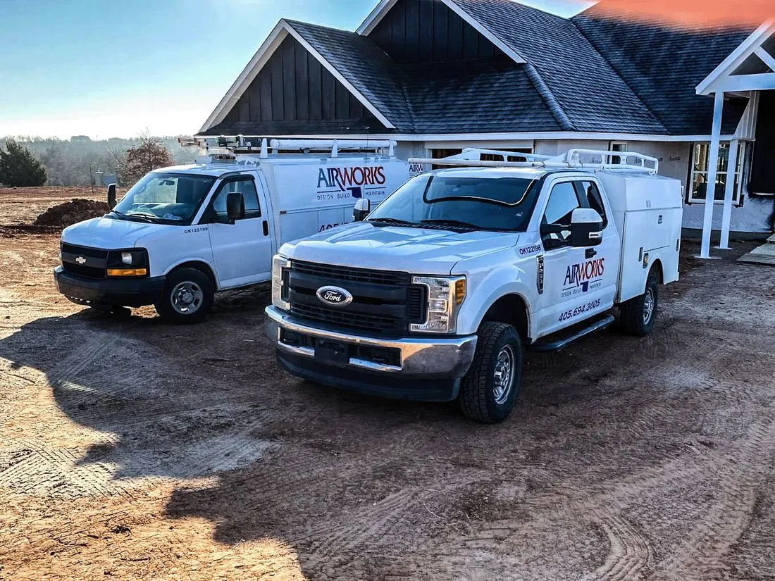 Air Works branded service trucks arriving at an Oklahoma City area home